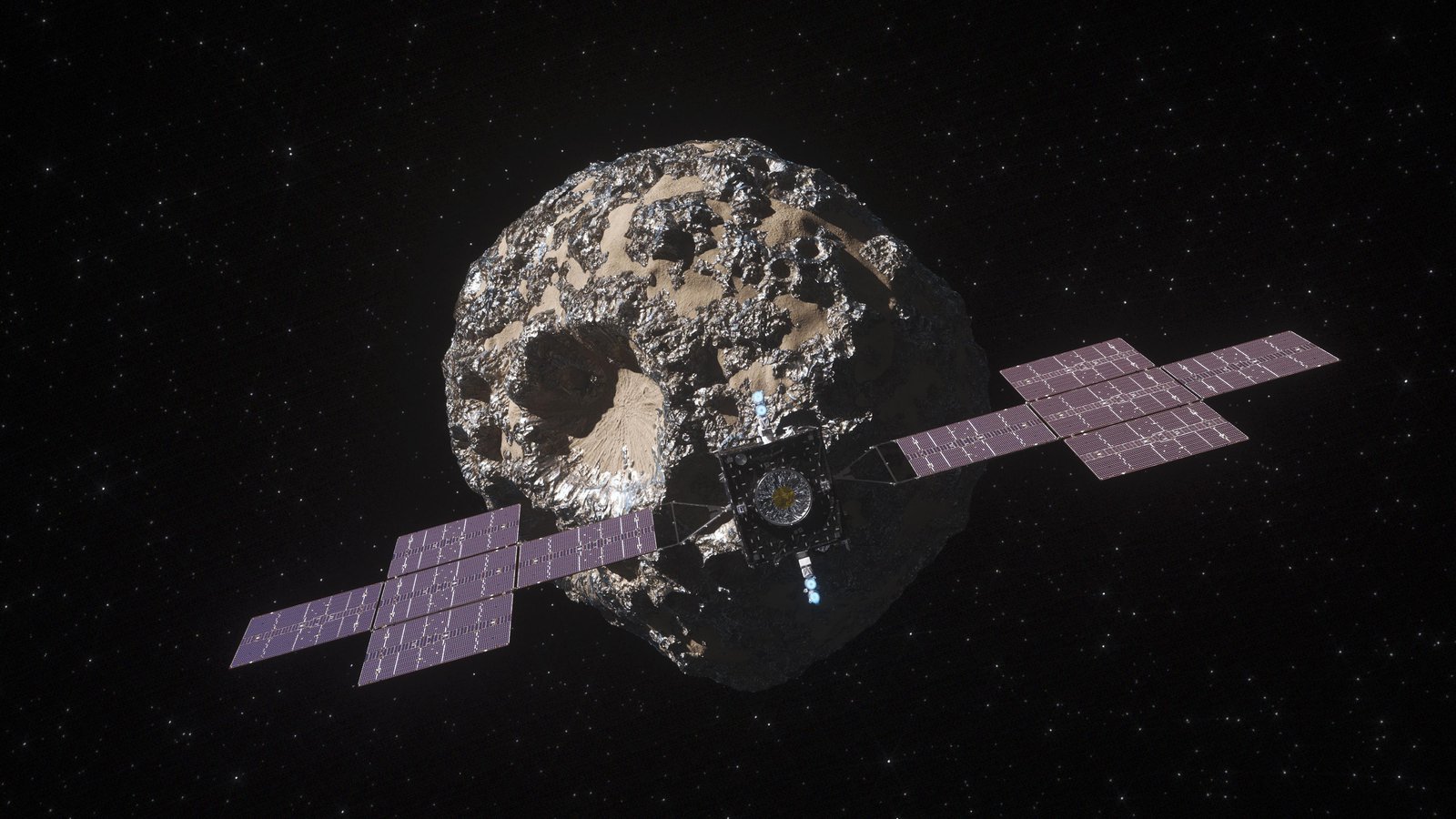 A metallic spacecraft that has purple solar panels shaped like plus-signs on either side approaches the rocky and metallic asteroid, Psyche. The asteroid is covered in craters, including one prominent circular crater. The spacecraft and asteroid are set in the black background of space.