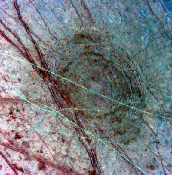Europa's surface in tones of blue and red, large circular pattern in center, with  criss-crossing lines and cracks.