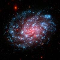 Image of a pink and blue spiral galaxy.