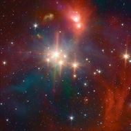 IR Coronet: This star-forming region has stars of many ages and sizes. This Spitzer infrared image shows both the young stars and the gas and dust from which the stars form.