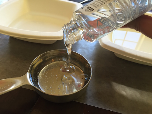 pouring glue into a half cup measuring cup