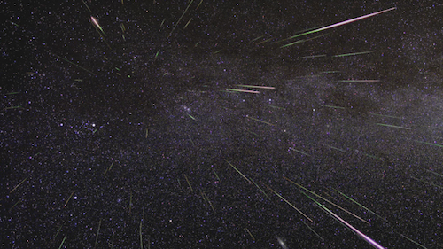 A photograph of meteors streaking through the sky, taken during the Perseid meteor shower.