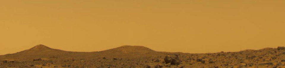 The orange-colored Martian sky during the daytime.