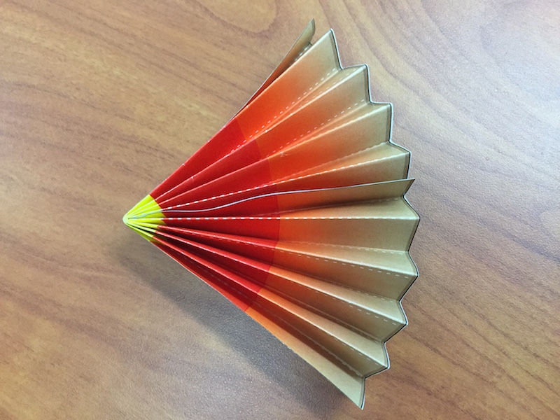 the fan is glued together, making a pie piece shape or wedge