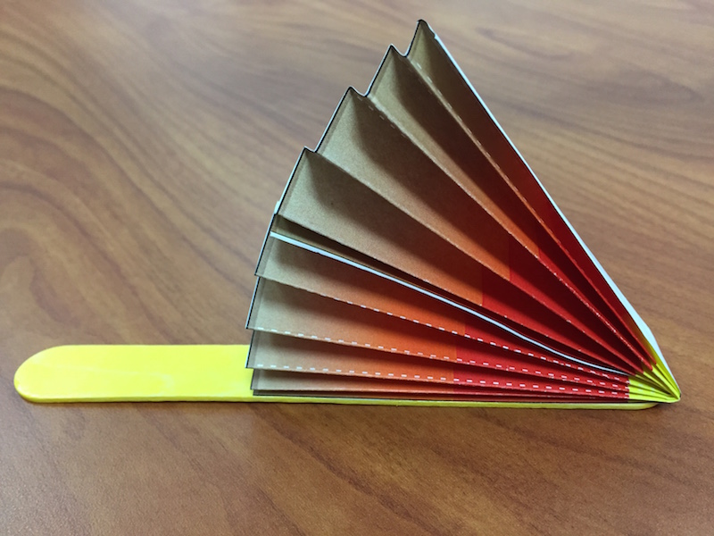 a photo of the first fan wedge glued to a popsicle stick