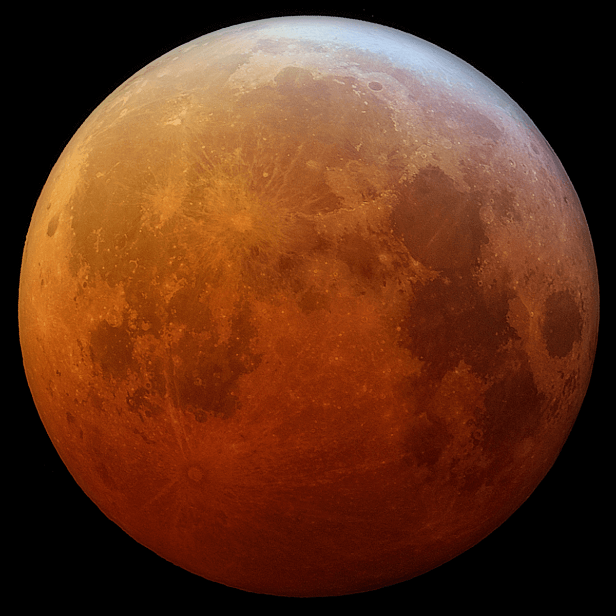 Photo of the Moon appearing reddish in color.