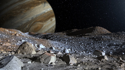 What it might look like if you were standing on Europa’s frozen surface. Jagged rocks rise from the icy surface. Jupiter and its Great Red Spot are visible in the background beyond the dark and rocky surface of Europa. The sky beyond Jupiter and its moon’s surface is black with faint sprinkles of white stars.