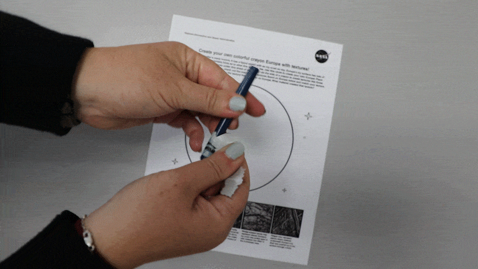 Gif of hand unwrapping a blue crayon’s paper.