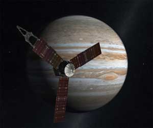 Artist's rendering of Juno spacecraft, with Jupiter in the background.