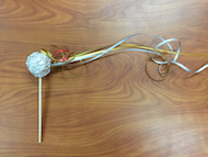 a photo of the craft activity comet on a stick made of tin foil and ribbon