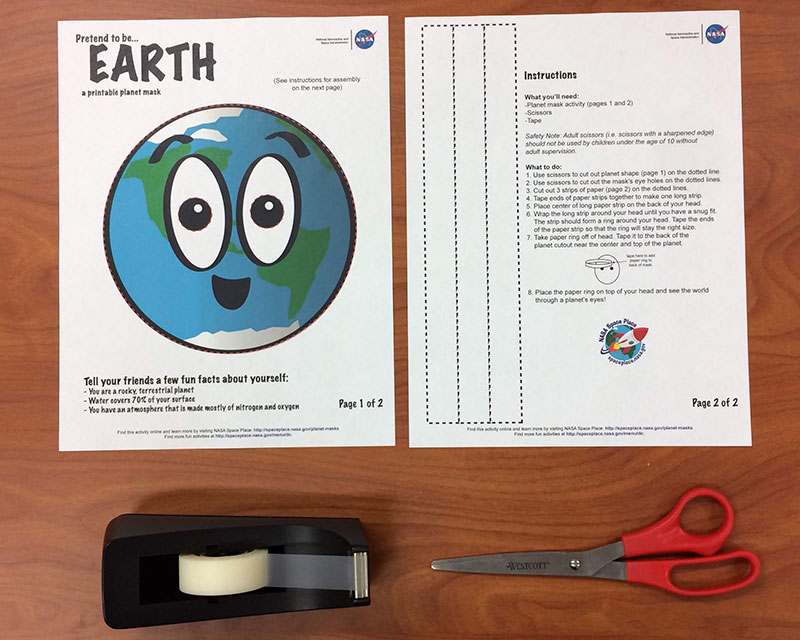 a photo of a printout of the mask activity, tape, and scissors all laid out on a table