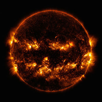 Image of the Sun that resembles a carved pumpkin.