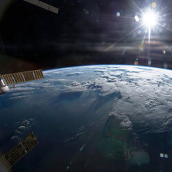 Image of the Earth with the Sun behind it. Credit: NASA/Terry Virts