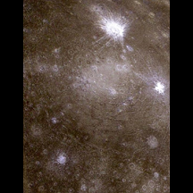Closer view of Callisto, dark surface, with large, bright crater.