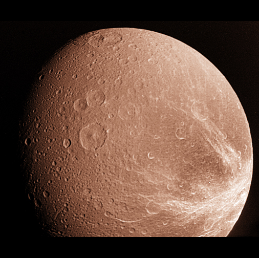 Dione looks pink and white in this Voyager image, with lots of craters.