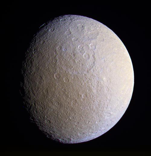 The full sphere of Rhea floats in space.