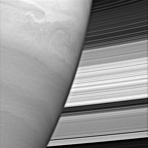 View of part of Saturn with rings behind.