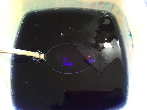 purple glue and water mixture in a bowl